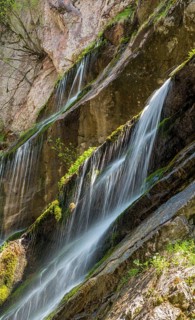 Waterfall on mossy slope
