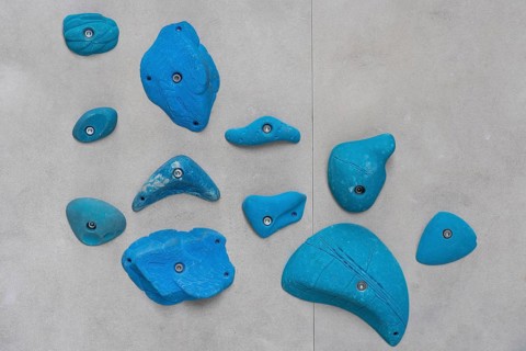 Blue via ferrules or climbing grips on grey wall