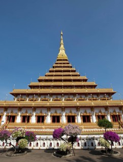 Flowering bushes in front of nine-story stupa Phra Mahathat Kaen Kakhon