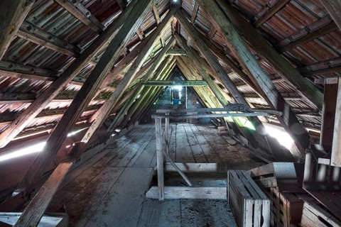 Attic with empty wooden boxes of an old farm