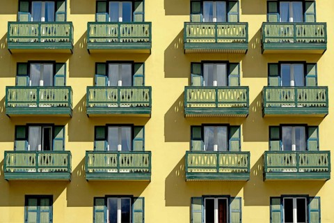 Yellow building facade with balconies