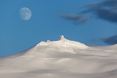 Snow-covered Snaefell volcano with Snaefellsjokul glacier and full moon