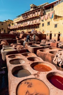 Worker dyeing leather