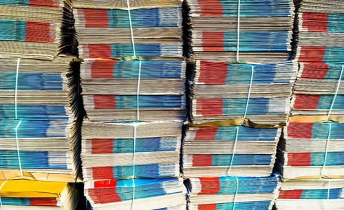 Several stacks with bundles of newspapers
