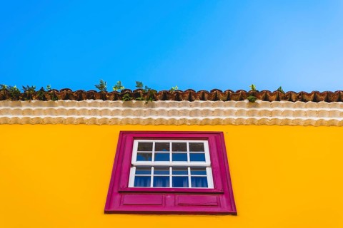 Yellow facade with pink window