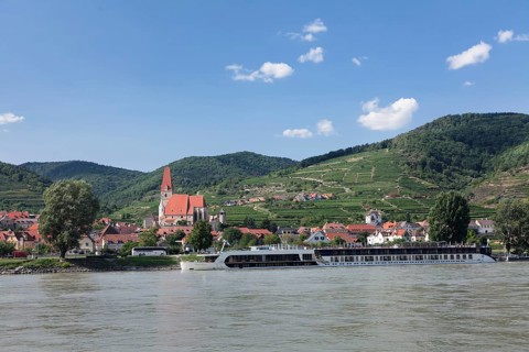 Panoramic view over the Danube to Spitz an der Donau with parish church St. Mauritius