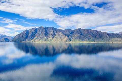 Cloudy sky with water reflections in Lake Hawea