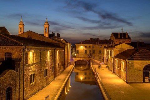 View from the Trepponti bridge on canal with village at dusk