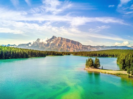 Minnewanka Lake with small peninsula with trees
