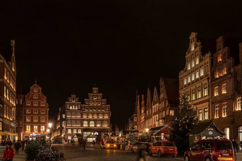 Old gabled houses in Christmas lighting in the evening