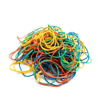 Multicolored elastics on pile on white background