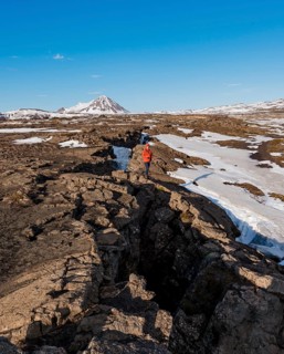 Man stands at Continental Rift between North American and Eurasian Plate