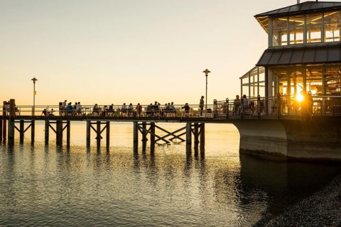 People on footbridge at sunset