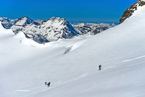 Ski tourers ascending to the summit of Aebeni Fluh