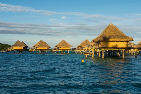 Overwater bungalows on stilts in luxury hotel