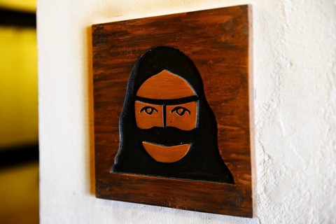 Toilet sign with veiled woman