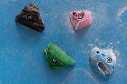 Coloured via ferrules or climbing grips on blue wall