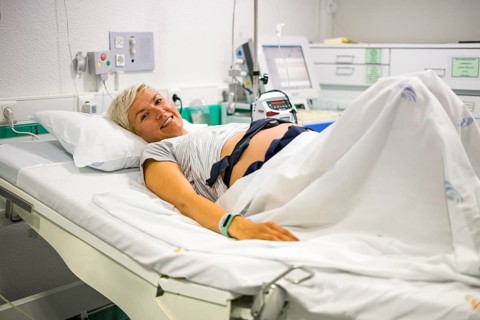 Pregnant woman with ctg recording the fetal heartbeat and the uterine contractions