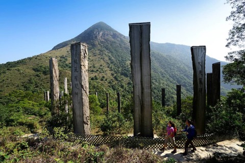 Hikers in front of wooden stelae at Wisdom Path