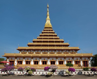 Flowering bushes in front of nine-story stupa Phra Mahathat Kaen Kakhon