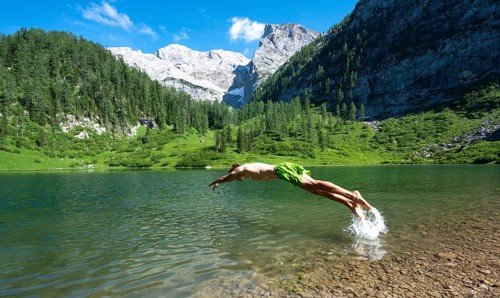 Young man jumps into the water