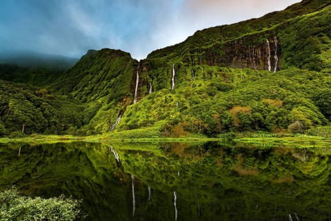 Waterfalls with lake Poco Ribeira do Ferreiro in green landscape