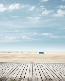 Blue VW Beetle Convertible at the beach of St. Peter-Ording