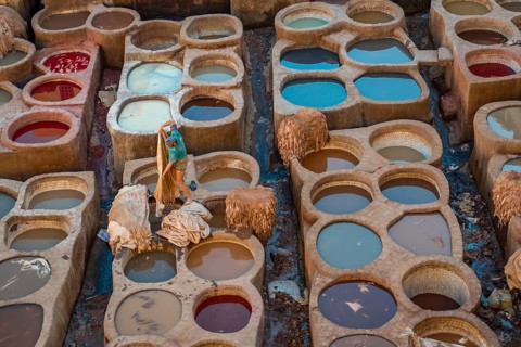Worker dyeing leather