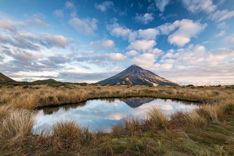 Stratovolcano Mount Taranaki or Mount Egmont reflected in Pouakai Tarn