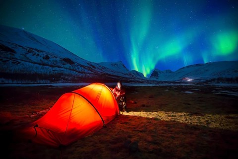 Northern Lights (Aurora borealis) over a tent in winter
