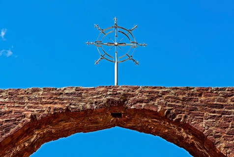 Stylized cross of the orthodox Ethiopian church at the entrance portal to the church Abreha wa Atsbaha