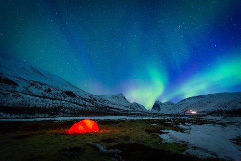 Northern Lights (Aurora borealis) over a tent in winter