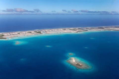Island in the coral reef with clouds