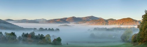 Autumn foggy atmosphere with Schneeberg and pilgrimage church Hafnerberg