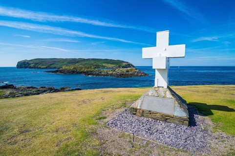 Huge cross before the small island calf of Man on the south side of the Isle of Man