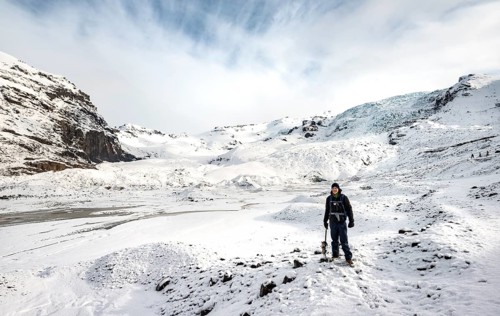 Hiker with ice pick on the glacier