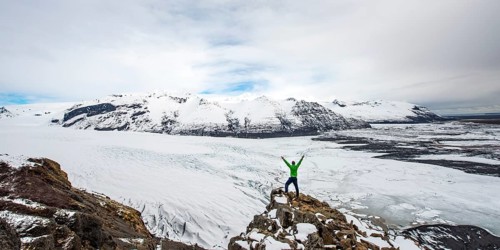 Hiker stretches his arms up