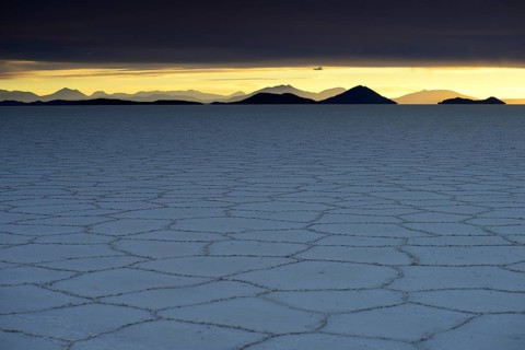 Honeycomb structure on the salt lake at sunset with clouds