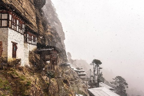 Buddhist nunnery in the mountains during snowfall