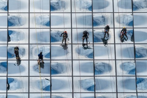 Facade climbers cleaning the windows of the glass facade