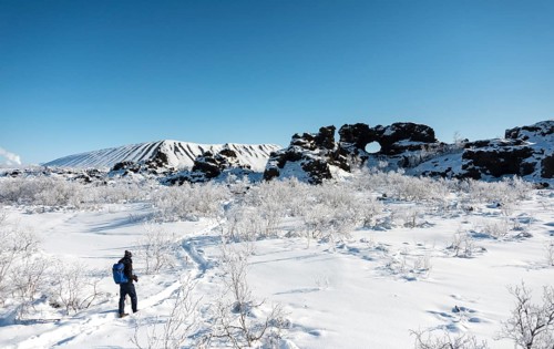 Man on hiking trail in the snow in sunshine