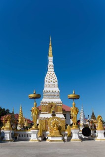 Chedi of Wat Mahathat Temple with Wheel of Life and golden Buddha figures