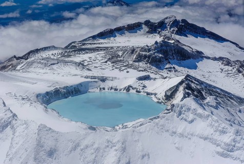 Aerial view of a tuquoise crater lake on top of Mount Ruapehu