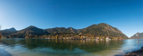 View over the lake with Jochberg and Herzogstand and place Walchensee in autumn