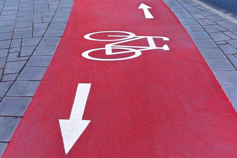 Red cycle path with white markings