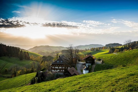 View of hilly landscape with farmhouse