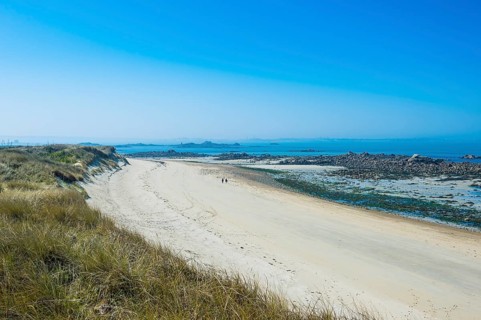 Overlook over a sand beach at the north coast of Herm