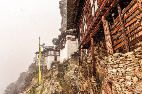 Buddhist nunnery in the mountains during snowfall