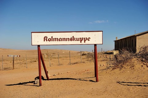 Kolmanskop sign standing in front of the former diamond town