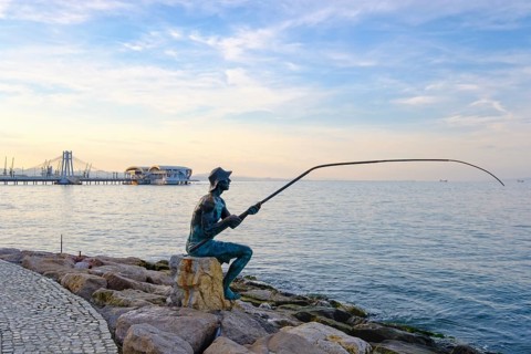 Bronze figure angler on waterfront
